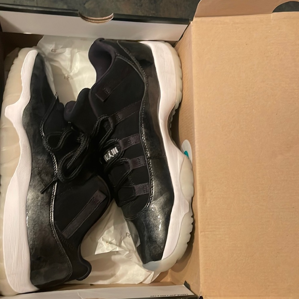 Black and white metallic silver Jordan 11s barons
